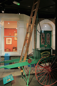 Re-creation of an Edwardian house, with a lamplighter's cart in the foreground